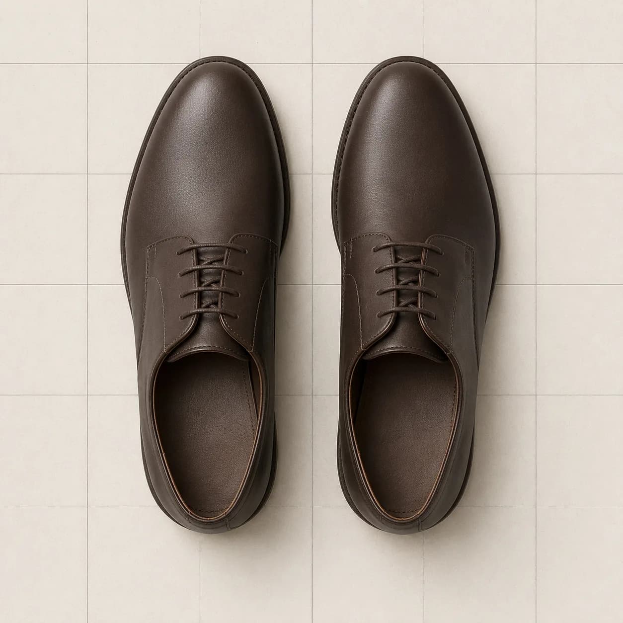 A pair of leather derbies placed side by side and parallel.